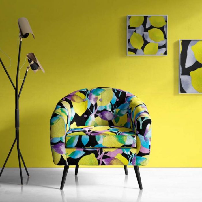 Turnowsky colorful floral chair in front of yellow wall