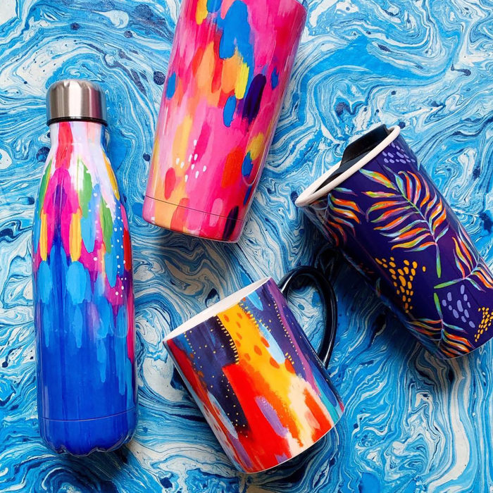 Colorful bottle, bug and travel tumblers on a blue swirl background