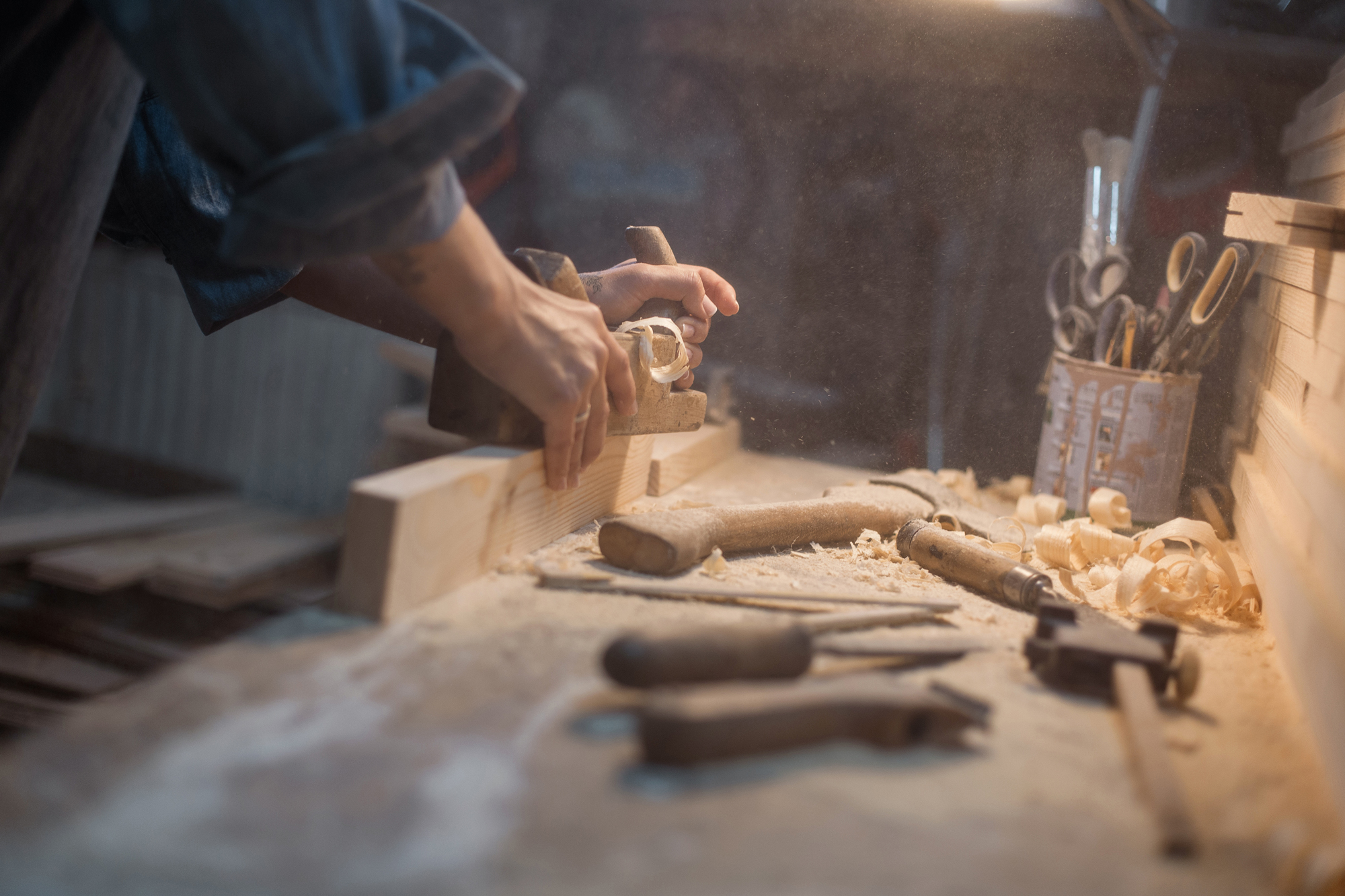 Tools for woodworking are arranged on a wooden background