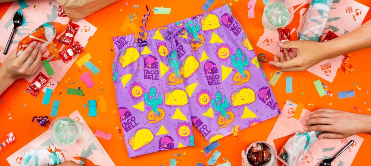 Purple shorts with a Taco Bell themed print on an orange background