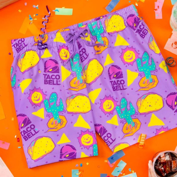 Purple shorts with a Taco Bell themed print on an orange background